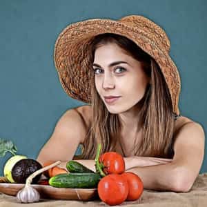 mujer con una piel hermosa mostrando alimentos saludables