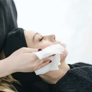 mujer realizando limpieza y cuidado de la piel en su cara